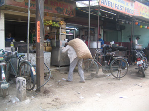 man carrying heavy bag