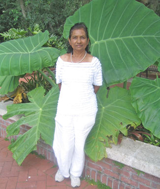 author standing against the large fronds